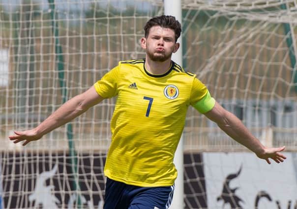 Scotland's forward and captain Oliver Burke celebrates after scoring during the Maurice Revello International tournament Under 20 football match between Scotland and South Korea at the Parsemain stadium in Fos-sur-Mer, southern France, on June 2, 2018. / AFP PHOTO / BERTRAND LANGLOISBERTRAND LANGLOIS/AFP/Getty Images
