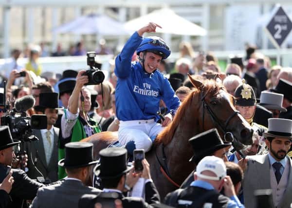 Winning jockey William Buick acknowledges Masar after the 16-1 shots impressive victory. Picture: PA.