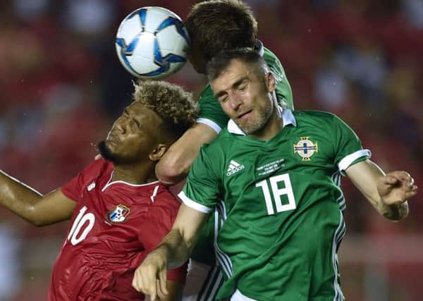 Aaron Hughes, right, is still undecided about whether to carry on playing. Picture: AFP/Getty.