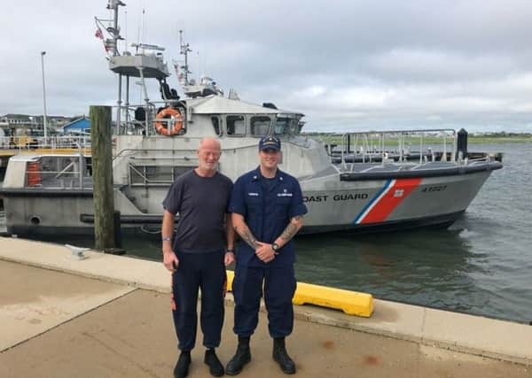 Duncan Hutchison poses alongside Eric Thornton, a member of the US Coast Guard, who helped rescue him off the coast of New Jersey. Picture: US Coastguard