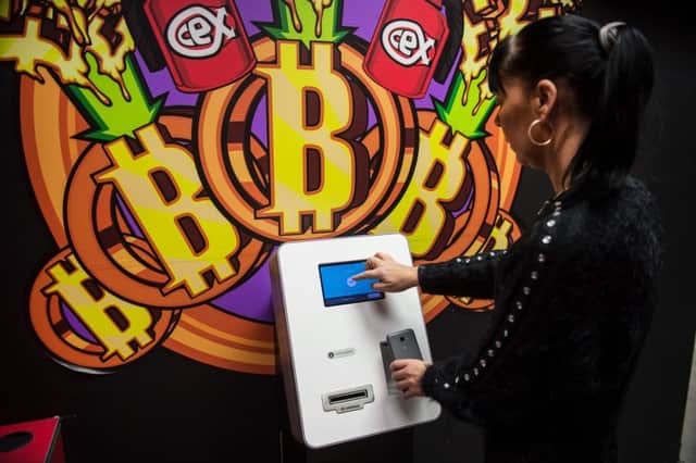 A customer uses a 'modest comission' Bitcoin vending machine in a CeX store in Glasgow. Picture: John Devlin