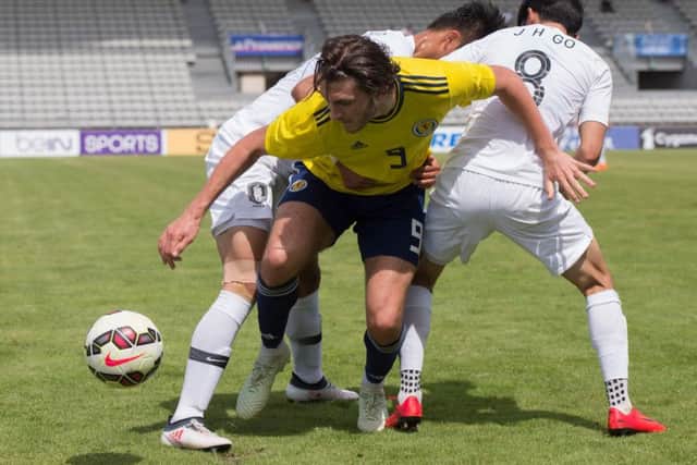Fraser Hornby in the thick of things during Scotland Under-21s 2-1 victory over South Korea. Picture: AFP/Getty