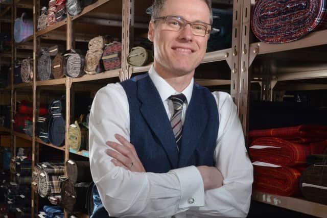John Kinloch Anderson with bolts of tartan at the company's Leith base, where the fabric is also manufactured. Picture: Jon Savage