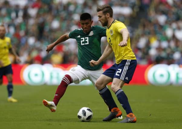 Scotland right-back Stephen ODonnell battles with Mexicos Jesus Gallardo at Estadio Azteca. Picture: AP.