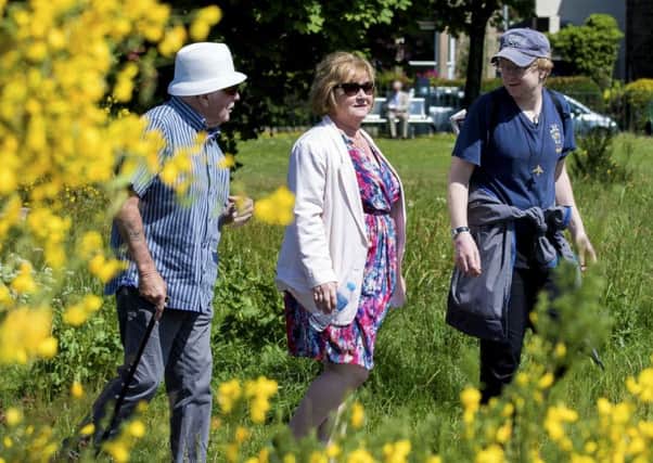 Scottish minister for mental health Maureen Watt takes a stroll with locals in Scotland's first ever dementia-friendly park, in Stirling