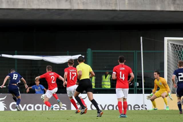Celtic youngster Michael Johnston fires the ball past England U21 goalkeeper Freddy Woodman to give Scotland U21 the lead in last nights Toulon Tournament semi-final.