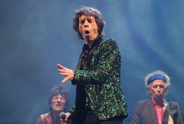 Mick Jagger with Ronnie Wood (left) and Keith Richards (right) from the Rolling Stones in 2013. The band has toured regularly for more than five decades. Picture: Yui Mok/PA Wire