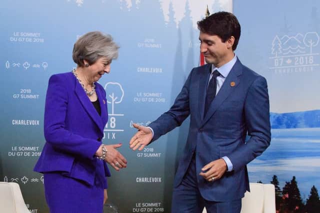 Theresa May is greeted by Justin Trudeau on the first day of the G7 Summit. Picture:Leon Neal/Getty