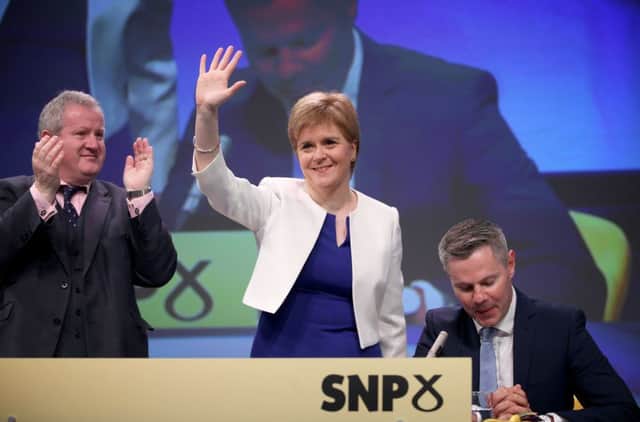 Nicola Sturgeon arrives on stage at the SNP's spring conference in Aberdeen yesterday. Picture: PA