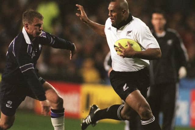 AUCKLAND, NEW ZEALAND - JULY 02: All Black Jonah Lomu prepares to fend off Scotland's Cameron Murray in the second test at Eden Park, Auckland, Saturday. New Zealand won 4814. (Photo by Ross Setford/Getty Images)