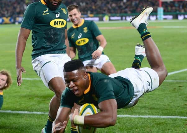 South African winger Aphiwe Dyantyi dives over during a thrilling Test match in Johannesburg.  Photograph: Getty Images