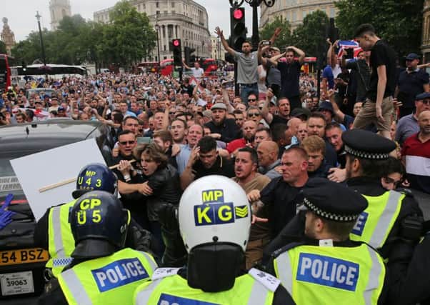 Protesters scuffle with police at the junction of Whitehall and The Mall during a gathering by supporters of far-right spokesman Tommy Robinson. Picture: Getty Images