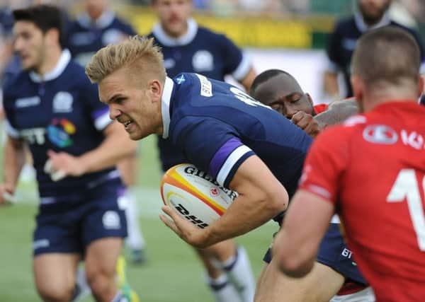 Chris Harris, selected at outside centre, breaks through the weak Canada defence. Pict ure: David Gibson/Fotosport.
