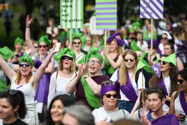 Women wave their arms in the air during Processions 2018 to mark 100 years since women won the right to vote in the UK. Picture: Jeff J Mitchell/Getty Images