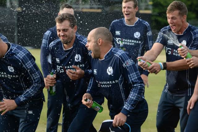 Kyle Coetzer, right, Calum MacLeod, centre, and Mark Watt lead the celebrations after Safyaan Sharif took the winning wicket. Picture: Getty.