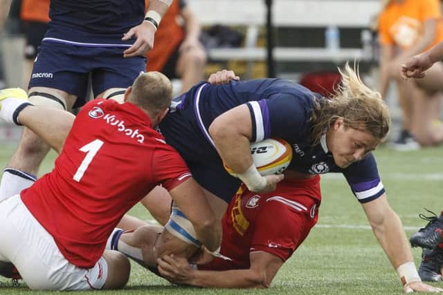 David Denton is tackled by Canadas Noah Barker during Scotlands 48-10 victory in Edmonton last weekend. Picture: AP.