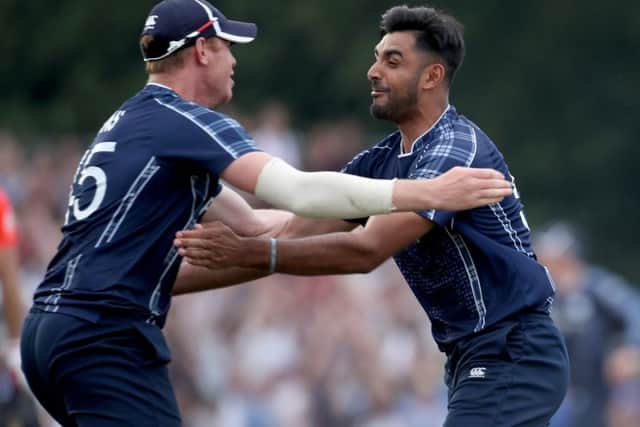 Alasdair Evans (left) and Safyaan Sharif celebrate beating England in the ODI at the Grange. Picture: PA