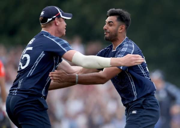 Alasdair Evans (left) and Safyaan Sharif celebrate beating England in the ODI at the Grange. Picture: PA