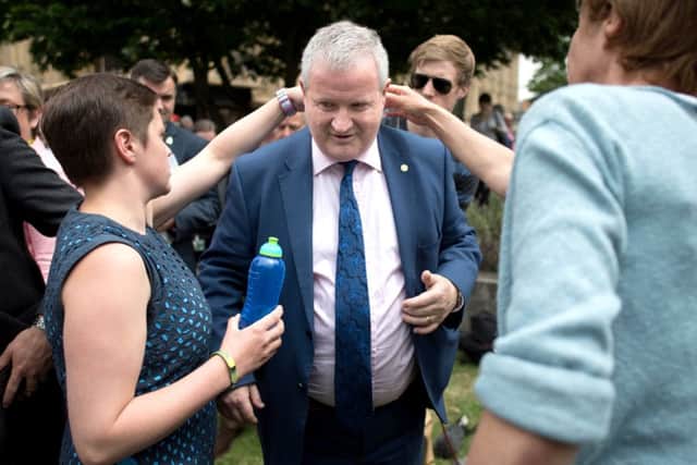 Ian Blackford surrounded by SNP MPs  in College Green after he was kicked out of House of Commons sittings for the rest of the day after repeatedly challenging Speaker John Bercow. Picture: PA