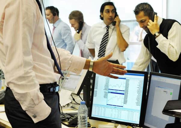 Currency traders at Worldwide Currencies Ltd in London's Canary Wharf stand at their desks to cold call during 'power hour'. So-called 'robo-trading' is reducing demand for such practices. Picture: PA