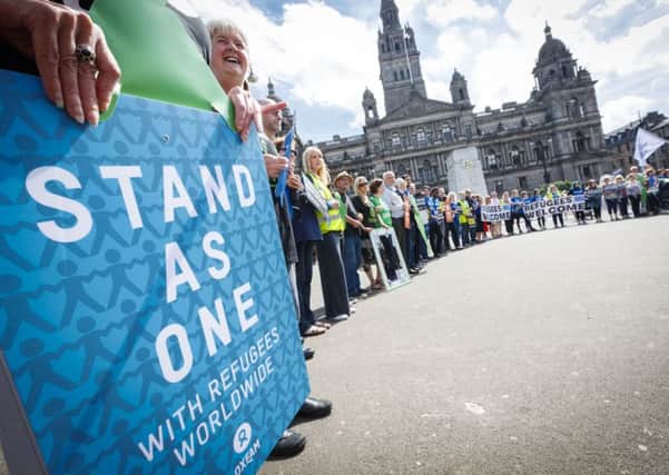 People gather in Glasgow's George Square last year to mark World Refugee Day. Picture: Roddy Scott.