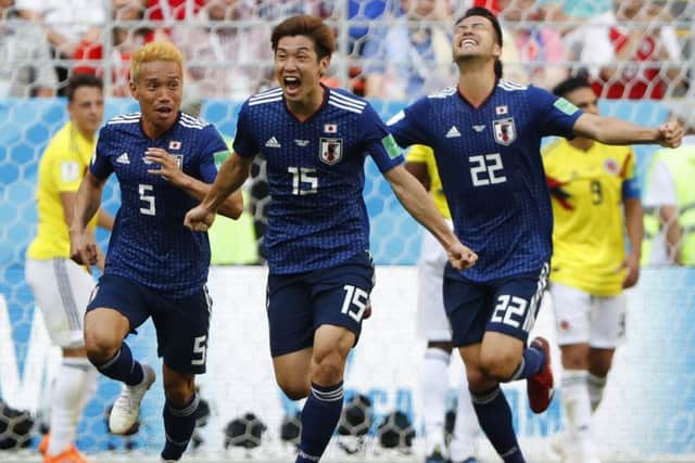 Japan's forward Yuya Osako (C) celebrates with team-mates after scoring against Colombia. Picture: AFP/Getty