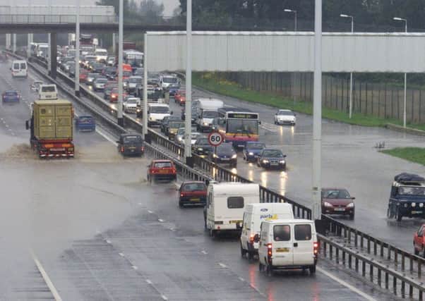 Flooding has ground parts of the M8 to a halt this morning. Picture: TSPL