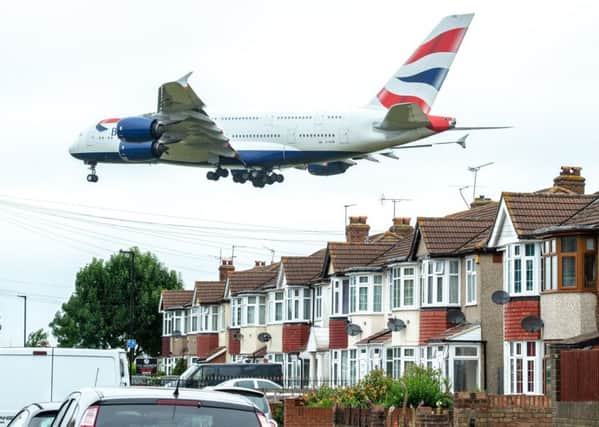 A plane comes in to land above Myrtle Avenue, a residential street in Heathrow. A third runway could lead to demolitions in the area. Picture: SWNS