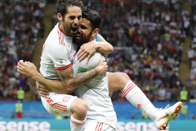 Diego Costa, right, celebrates with Spain team-mate Isco after scoring his side's second-half winner against Iran. Picture: AP