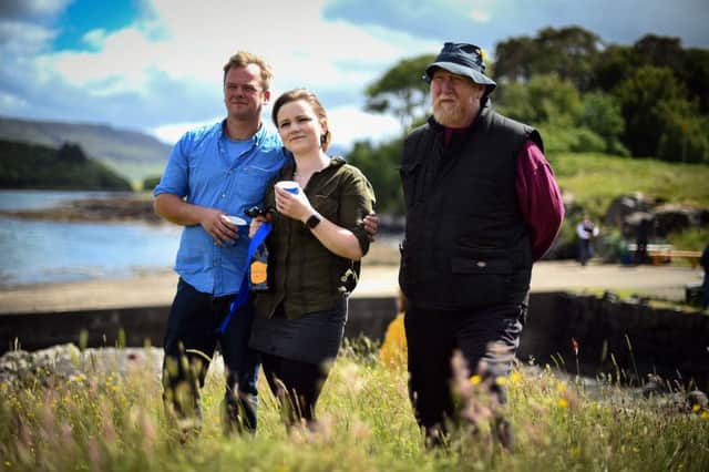 Ulva residents Rhuri Munro and his wife Rebecca Munro and Barry George celebrate the sale of the island to the residents on June 21. Andy Buchanan/AFP/Getty Images