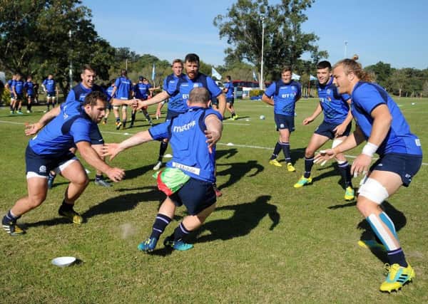 Nick Grigg tries to dodge his team-mates during a game of tag at Scotland training in Resistencia. Picture: Â©Fotosport/David Gibson