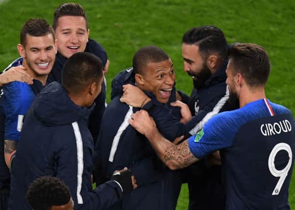 France's forward Kylian Mbappe (centre) celebrates with team-mates after scoring France's winning goal. Picture: AFP/Getty Images