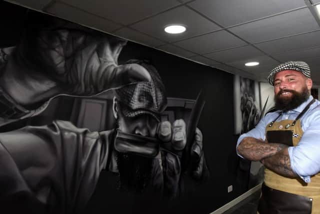 Revolution Barbershop owner Mark Reynolds with the new wall mural by Spanish artist Murales Lian (Pics by Fife Photo Agency)