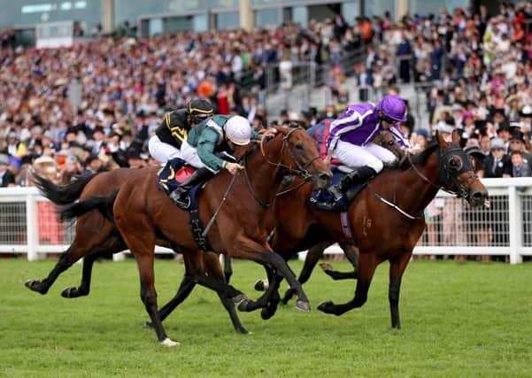 Merchant Navy (right) ridden by Jockey Ryan Lee Moore wins the Diamond Jubilee Stakes. Picture: PA.