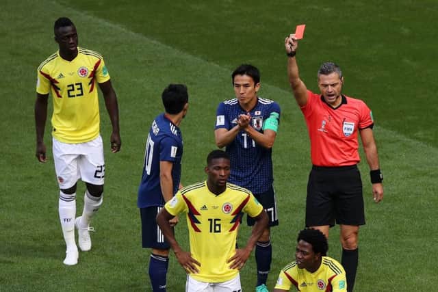Carlos Sanchez of Colombia is sent off by referee Damir Skomina in their match against Japan. Picture: Getty.