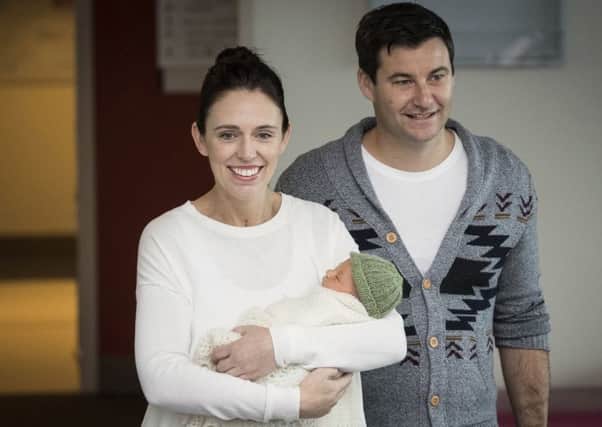 New Zealand Prime Minister Jacinda Ardern, left, with her partner Clarke Gayford, holds their newly born baby girl, Neve, at Auckland Hospital. Picture: Greg Bowker/New Zealand Herald via AP