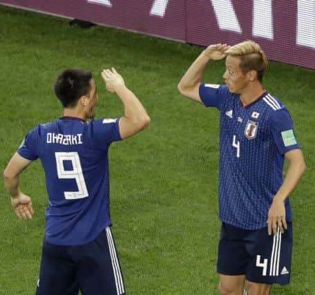 Japan's Keisuke Honda, right, celebrates with team-mate Shinji Okazaki. Picture: Mark Baker/AP