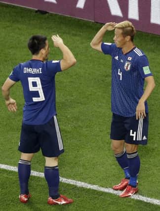 Japan's Keisuke Honda, right, celebrates with team-mate Shinji Okazaki. Picture: Mark Baker/AP
