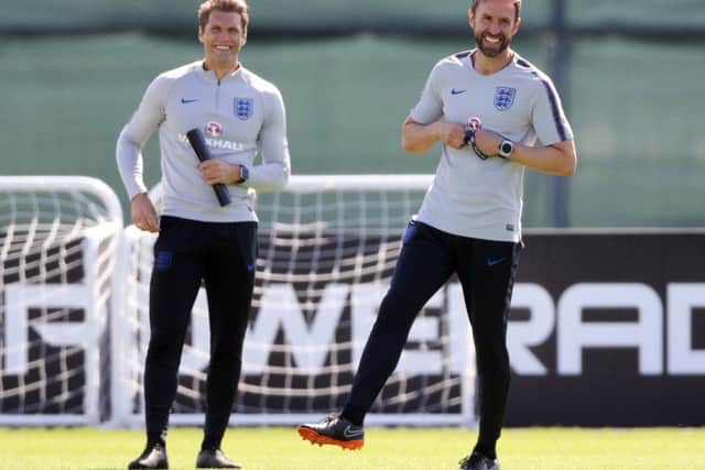 Training routines are proving productive for England strikers coach Allan Russell, left, and manager Gareth Southgate. Picture: PA.