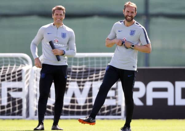 Training routines are proving productive for England strikers coach Allan Russell, left, and manager Gareth Southgate. Picture: PA.