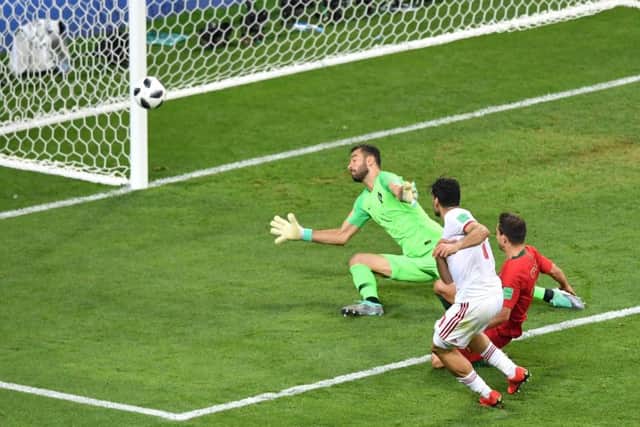 Portugal come within inches of elimination as Mehdi Taremi of Iran shoots just past Rui Patricios goal. Picture: Getty.