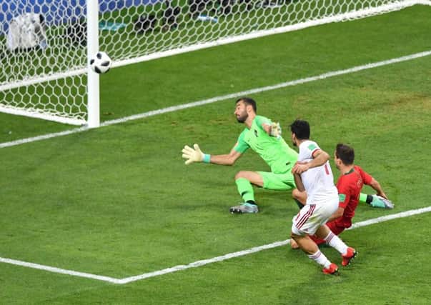 Portugal come within inches of elimination as Mehdi Taremi of Iran shoots just past Rui Patricios goal. Picture: Getty.