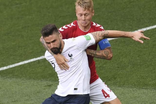 Olivier Giroud of France is manhandled by Simon Kjaer, but there was no penalty or VAR review. Picture: AFP/Getty