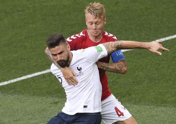 Olivier Giroud of France is manhandled by Simon Kjaer, but there was no penalty or VAR review. Picture: AFP/Getty