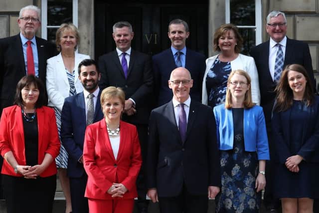 First Minister of Scotland, Nicola Sturgeon and Deputy First Minister John Swinney (centre right), with (left to right, back row) Mike Russell, Roseanna Cunningham, Derek Mackay, Michael Matheson, Fiona Hyslop, Fergus Ewing, (left to right, centre row) Jeane Freeman, Humza Yousaf, Shirley-Anne Somerville and Aileen Campbell.