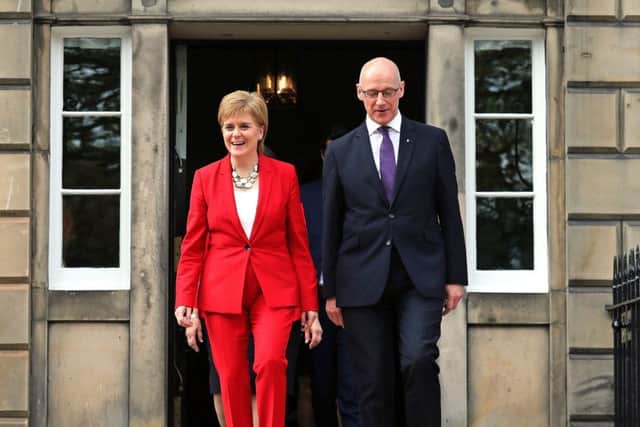 First Minister Nicola Sturgeon and Deputy First Minister John Swinney lead out the new look cabinet. Picture: PA