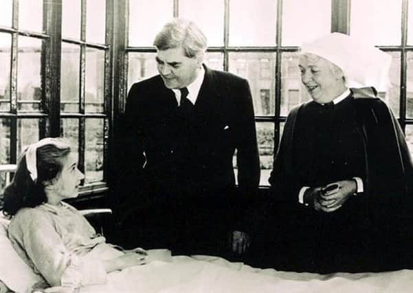 Aneurin Bevan talks to the NHS's first patient, 13-year-old Sylvia Diggory. Picture: Trafford Healthcare NHS Trust/PA