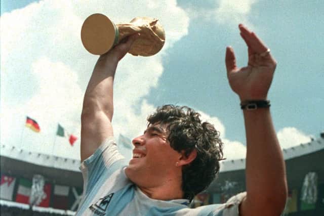 (FILE) Argentina's soccer star team captain Diego Maradona brandishes the World Cup won in 1986. Picture: STAFF/AFP/Getty