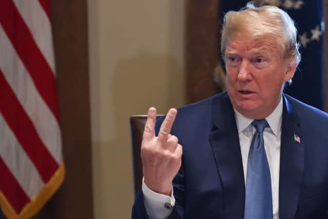 Lost in translation: Donald Trump makes a gesture that does not have the same connotations in the US as in the UK (Picture AFP/Getty)