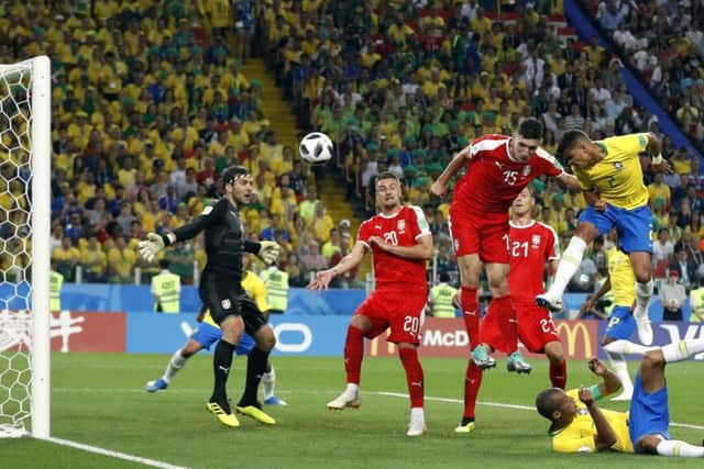 Thiago Silva heads home Brazils second goal to seal victory over Serbia and confirm his sides place at the top of Group E. Picture: AP